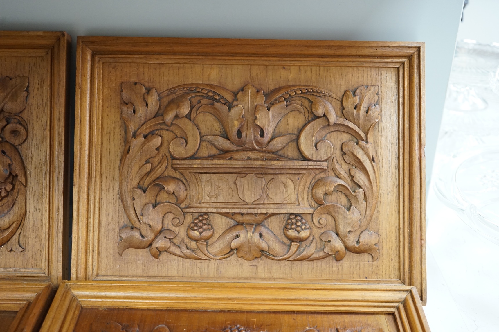 Six carved wood relief plaques, largest 31x46cm